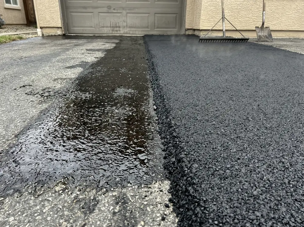 Fresh asphalt overlay laid over an old driveway with a tack coat